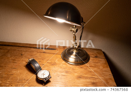 A wristwatch on an antique desk (horizontal) 74367568