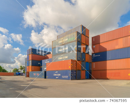 Shipping container site loading by crane in logistic port warehouse storage factory manufacturing business transportation import and export goods of freight business carrier. Shipping container site loading by crane in logistic port warehouse storage factory manufacturing business transportation import and export goods of freight business carrier. 74367595