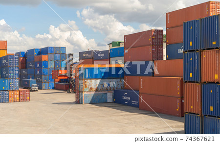 Shipping container site loading by crane in logistic port warehouse storage factory manufacturing business transportation import and export goods of freight business carrier. Shipping container site loading by crane in logistic port warehouse storage factory manufacturing business transportation import and export goods of freight business carrier. 74367621