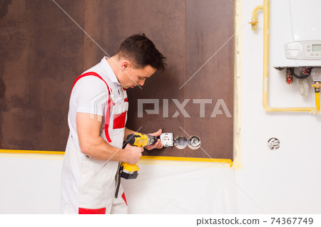 The electrician is happy to work at the new object 74367749