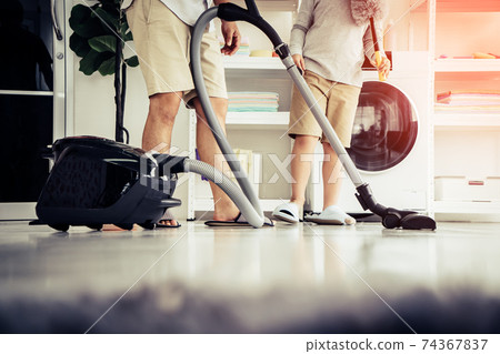Feet and legs of Father and son is doing house cleaning with joy and happiness, for Family togetherness cocnept. 74367837