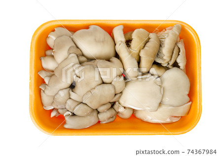 Fresh raw oyster mushrooms in package on white background 74367984