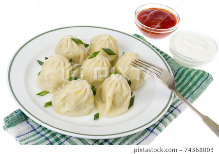 Boiled hot khinkali with meat, spices and ketchup. 74368003