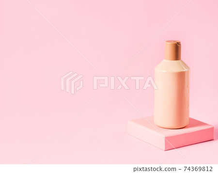Geometric pink stand podium displaying cosmetic body skin care generic bottle 74369812