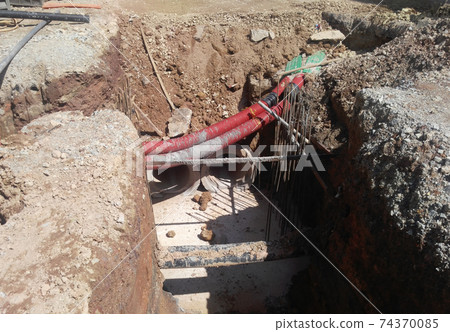 SEREMBAN, MALAYSIA -MARCH 02, 2017: Underground utility and services corrugated pipe lay by workers at the construction site. The corrugated  pipe used to protect cable lay inside it.   74370085