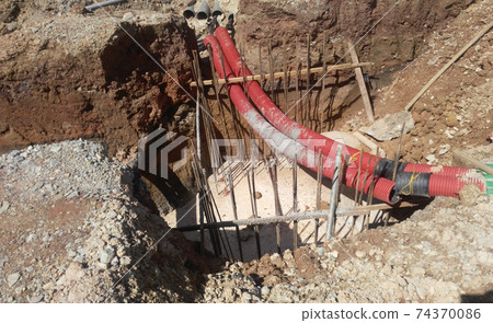 SEREMBAN, MALAYSIA -MARCH 02, 2017: Underground utility and services corrugated pipe lay by workers at the construction site. The corrugated pipe used to protect cable lay inside it. SEREMBAN, MALAYSIA -MARCH 02, 2017: Underground utility and services corrugated pipe lay by workers at the construction site. The corrugated pipe used to protect cable lay inside it. 74370086