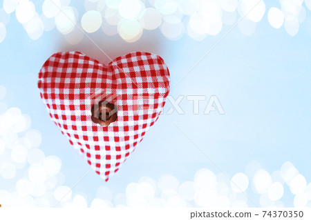 Heart with a flower in the middle on a blue background 74370350