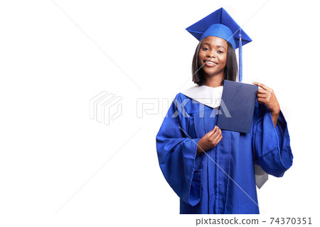 Black woman in a blue robe on a white background smiles and shows diploma Black woman in a blue robe on a white background smiles and shows diploma 74370351