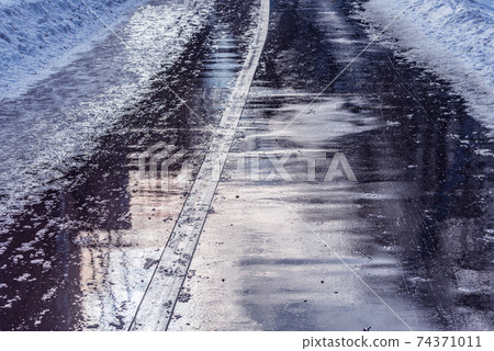 Wet asphalt road surface. 74371011