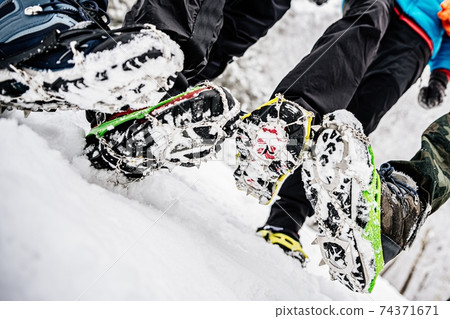 Close up of shoes with crampons. Winter trip to the mountains. Close up of shoes with crampons. Winter trip to the mountains. 74371671