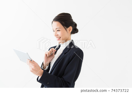 Smiling woman holding a tablet device Smiling woman holding a tablet device 74373722