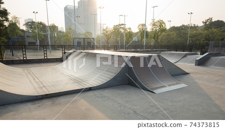 Skatepark ramps in the sunrise 74373815