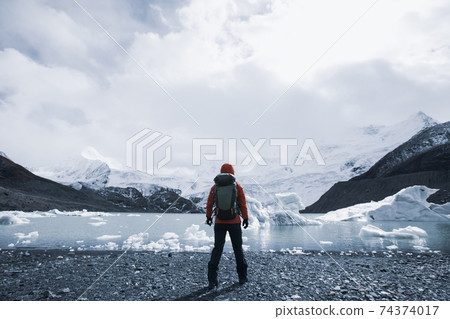 Woman hiker hiking in winter mountains Woman hiker hiking in winter mountains 74374017