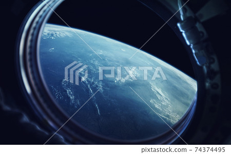 View from spaceship porthole. Earth and spacecraft. Elements of this image furnished by NASA 74374495