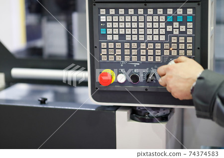 working with control panel of CNC machining center 74374583