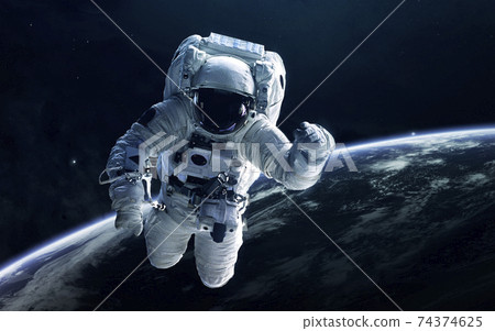 Astronaut in outer space. Elements of this image furnished by NASA Astronaut in outer space. Elements of this image furnished by NASA 74374625