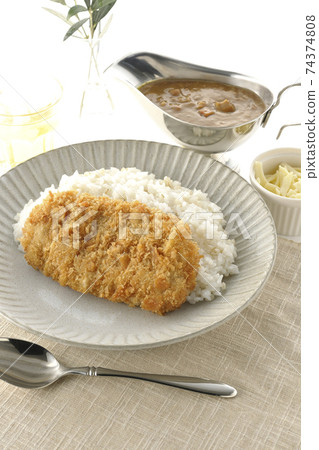 Curry pot with rice with pork cutlet and roux, natural cheese topping, tea and olive leaves Curry pot with rice with pork cutlet and roux, natural cheese topping, tea and olive leaves 74374808