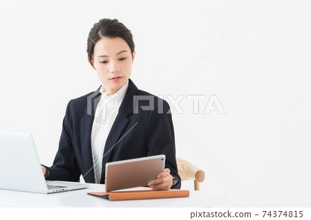 Portrait of a woman working at a desk Portrait of a woman working at a desk 74374815