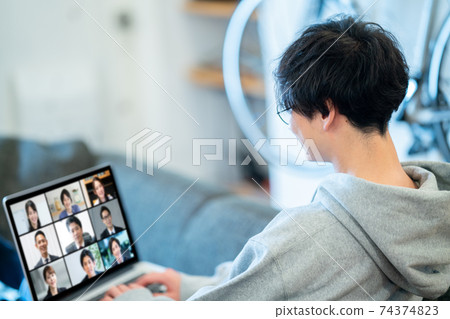 Back view of a man having an online meeting with remote work Back view of a man having an online meeting with remote work 74374823