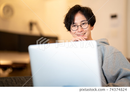 A man who relaxes and works as a remote worker 74374824