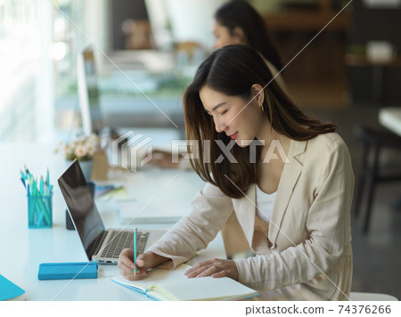 Businesswoman working with stationery and office supplies in office room Businesswoman working with stationery and office supplies in office room 74376266