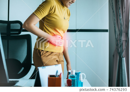 Women suffering from abdominal pain,Period cramps,Hands squeezing belly,Stomach pain ,Woman having painful stomach ache during working at home Women suffering from abdominal pain,Period cramps,Hands squeezing belly,Stomach pain ,Woman having painful stomach ache during working at home 74376293