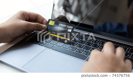 Online product purchase, Businessman use laptop register via credit cards to make online purchases, Shopping and mail, credit card online security, Online shopping concept. Online product purchase, Businessman use laptop register via credit cards to make online purchases, Shopping and mail, credit card online security, Online shopping concept. 74376756