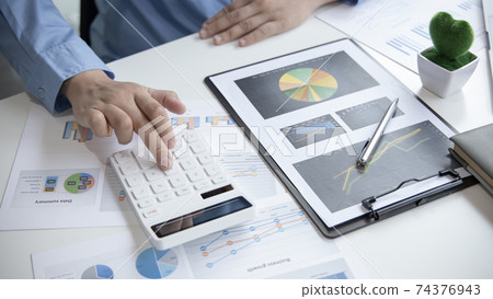 Financial businessman calculating corporate income tax data And analyzing charts of financial stocks that are in good condition with growth and progress, Investment in finance and accounting. 74376943