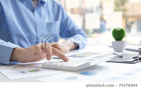 Financial businessman calculating corporate income tax data And analyzing charts of financial stocks that are in good condition with growth and progress, Investment in finance and accounting. 74376944
