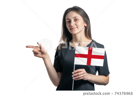 Happy young white woman holding flag England and points to the left isolated on a white background Happy young white woman holding flag England and points to the left isolated on a white background 74376968