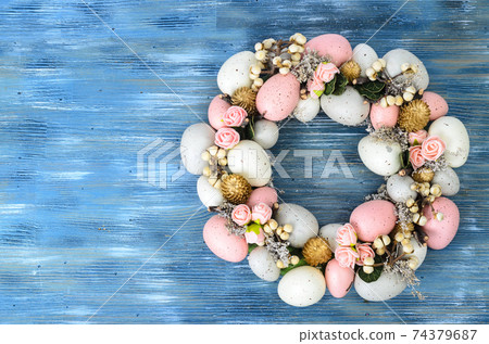 Easter wreath of colorful decorative eggs, flowers Easter wreath of colorful decorative eggs, flowers 74379687