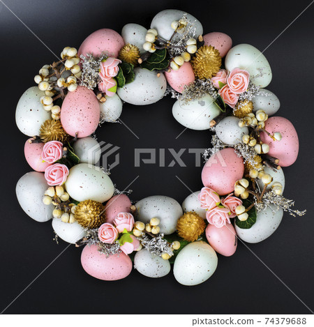 Easter wreath of colorful decorative eggs, flowers Easter wreath of colorful decorative eggs, flowers 74379688