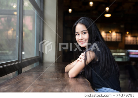Portrait of Cheerful young Asian girl with smiling posing at outdoor 74379795