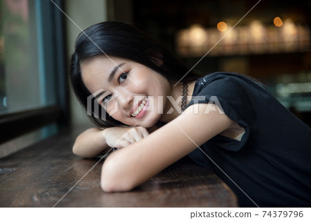Portrait of Cheerful young Asian girl with smiling posing at outdoor 74379796