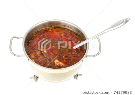 Saucepan with vegetable beetroot soup on white background. 74379988