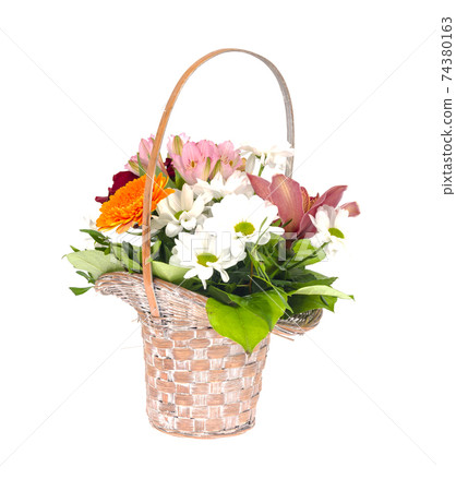 Wicker decorative basket with bouquet of beautiful flowers isolated on white background Wicker decorative basket with bouquet of beautiful flowers isolated on white background 74380163
