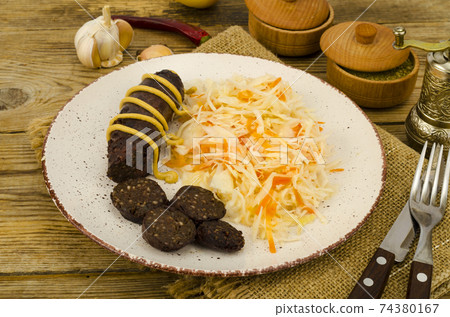 Black sausage with sauerkraut. Studio Photo 74380167