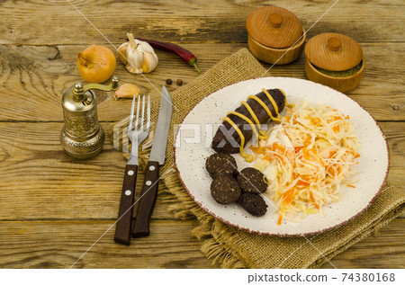 Black sausage with sauerkraut. Studio Photo 74380168