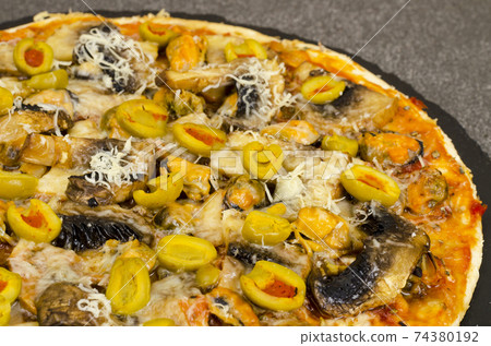 Pizza with mussels, mushrooms, green olives Pizza with mussels, mushrooms, green olives 74380192