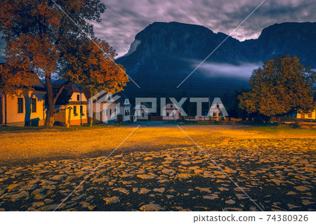 Early morning scenery in Rimetea with Piatra Secuiului mountain, Romania  74380926