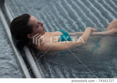 Seductive female resting in pool Seductive female resting in pool 74381727