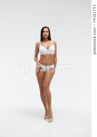 Slim woman in lingerie in studio 74381753