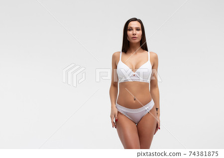 Slim woman in lingerie in studio 74381875