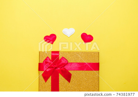 Happy Valentine's Day flatlay. Top view present gift box, hearts on on yellow color of the year 2021 background. Valentine day or New Year greeting card. panton 74381977