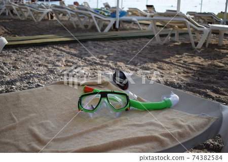 Mask and snorkel for scuba diving are on the seashore Mask and snorkel for scuba diving are on the seashore 74382584
