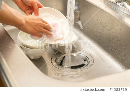 Hands of a man washing dishes 74383719