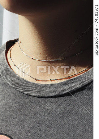 Tender jewerly on female neck, close up shot Tender jewerly on female neck, close up shot 74383971
