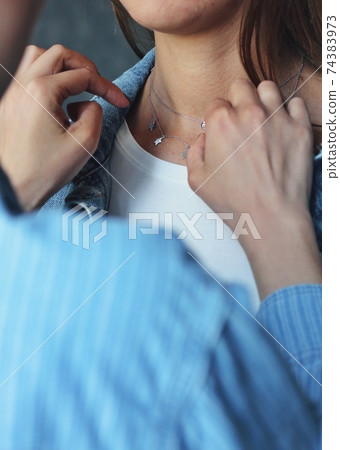 Tender jewerly on female neck, close up shot Tender jewerly on female neck, close up shot 74383973
