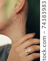 Tender jewerly for female ears, close up shot 74383983
