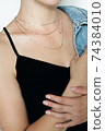 Tender jewerly on female neck, close up shot 74384010
